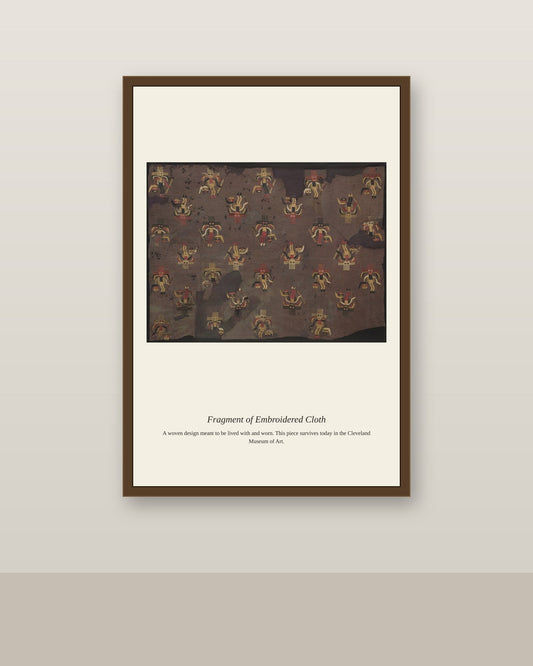 Fragment of Embroidered Cloth antique textile print shown framed on a wall in a styled room