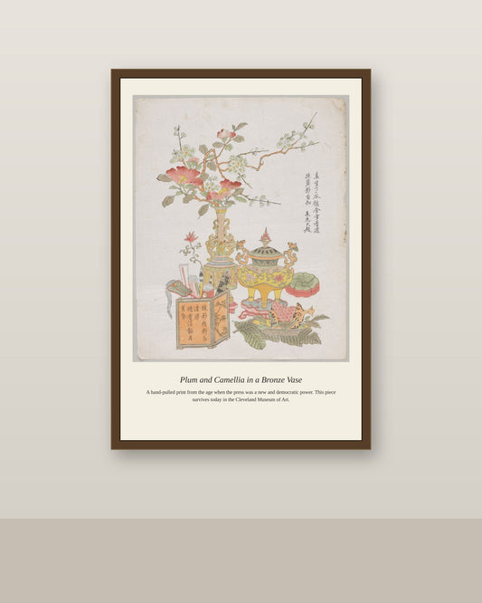 Plum and Camellia in a Bronze Vase antique botanical print shown framed on a wall in a styled room