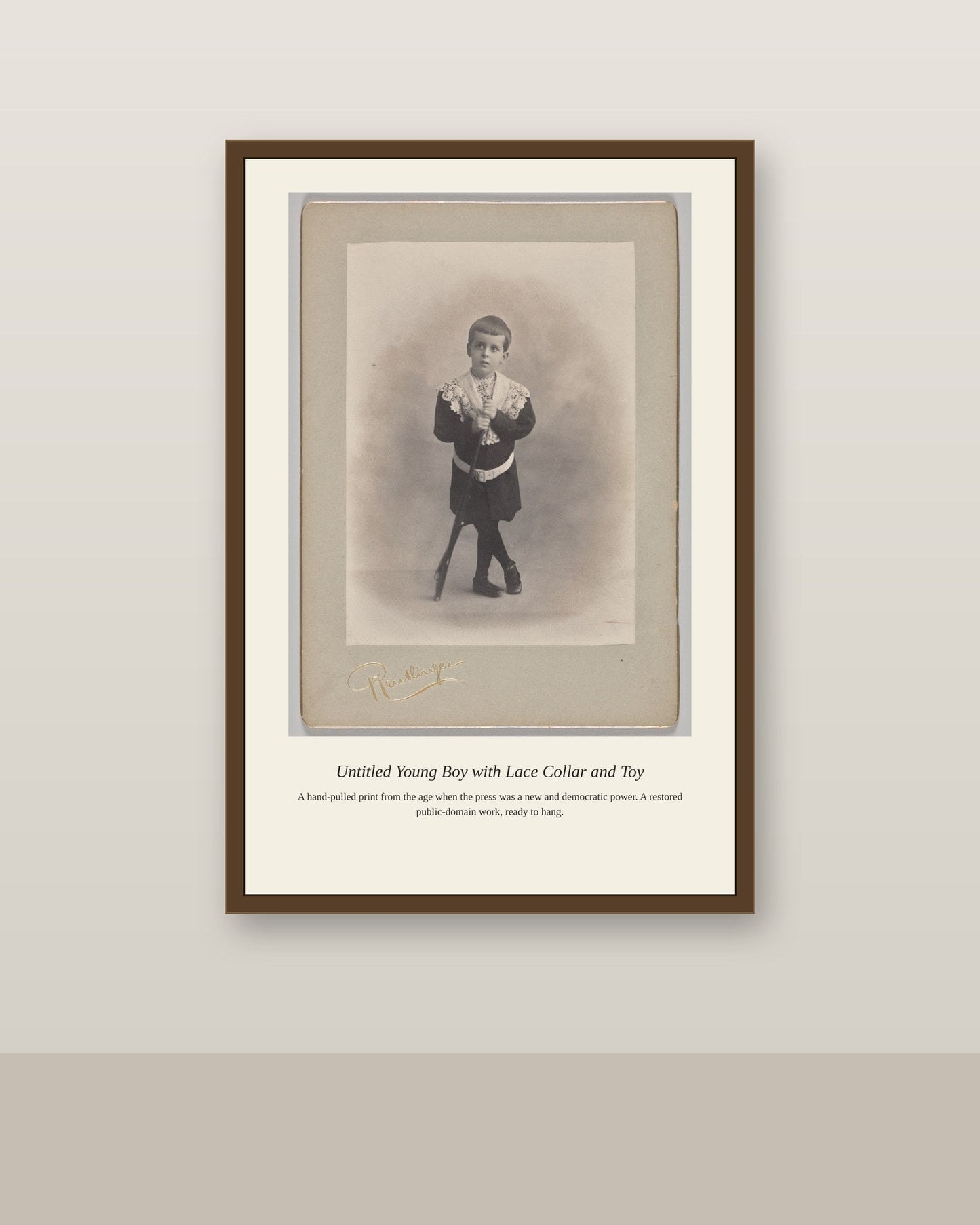 Young Boy with Lace Collar and Toy (2) antique art print shown framed on a wall in a styled room