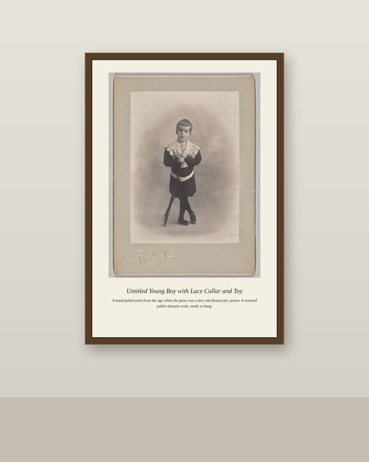 Young Boy with Lace Collar and Toy (2) antique art print shown framed on a wall in a styled room