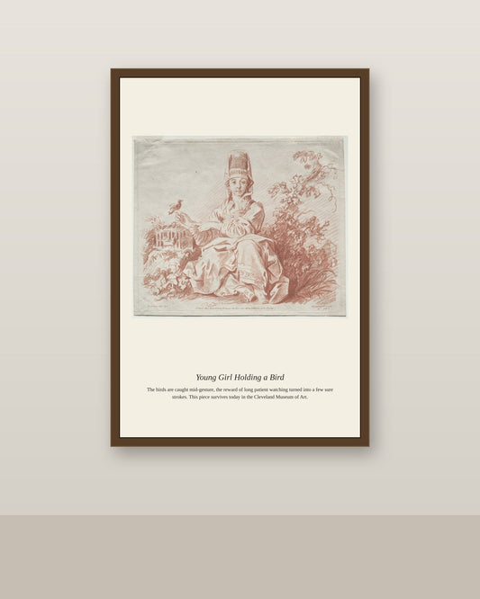 Young Girl Holding a Bird antique natural history print shown framed on a wall in a styled room