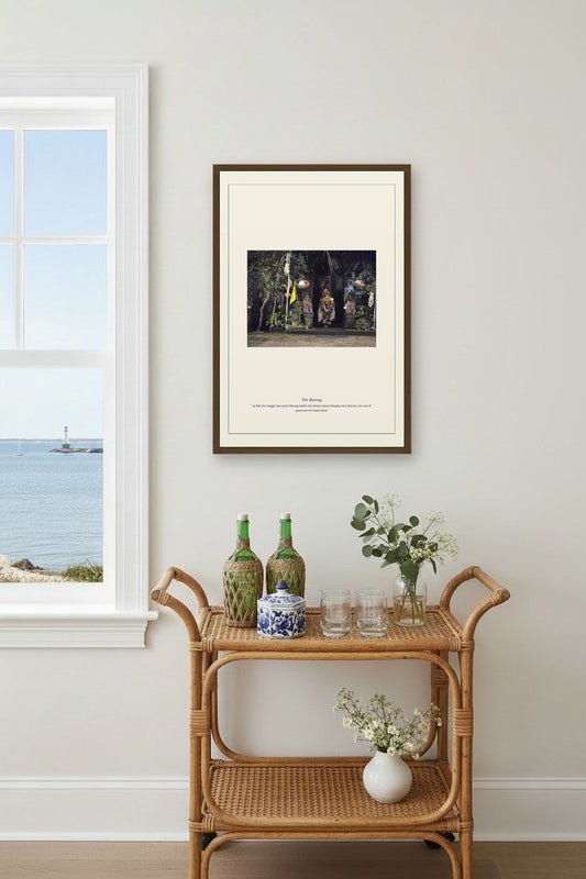 The Barong framed above a light wood sideboard beside a curtained window