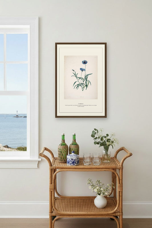 Cornflower art framed above a beige sectional sofa between two curtained windows