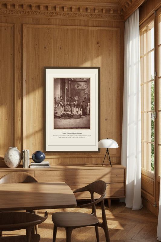 Framed Covent Garden flower sellers print on a wood-paneled dining room wall