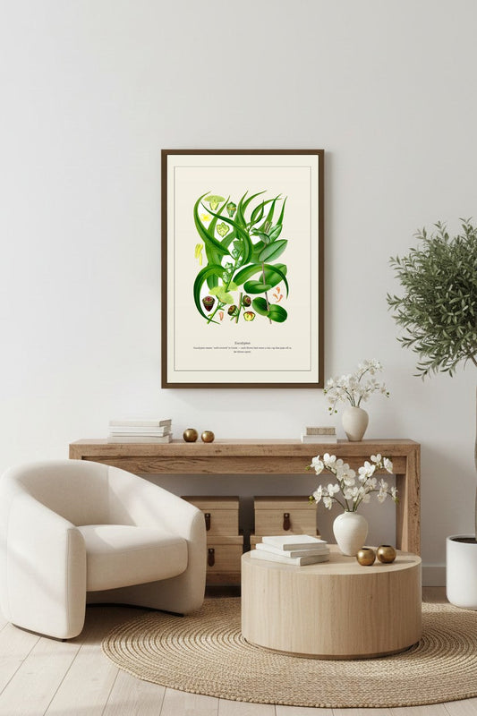 Eucalyptus botanical print hanging above a light wood console with orbs and vase