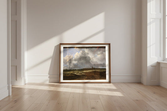 A Wooded Village behind Dunes — Jacob van Ruisdael Fine Art Poster shown framed and leaning against a wall in a sunlit room