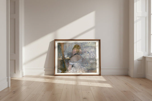 Woman at Her Toilette — Berthe Morisot Fine Art Poster shown framed and leaning against a wall in a sunlit room