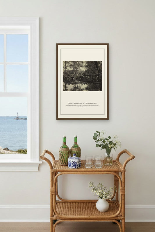 Military Bridge Across the Chickahominy photograph print framed above a rattan bar cart near a coastal window