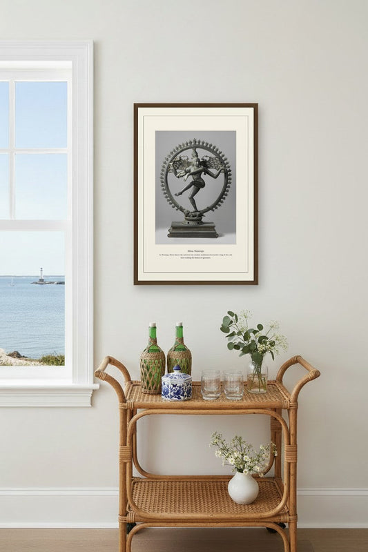 Shiva Nataraja bronze print above a rattan bar cart near a coastal window