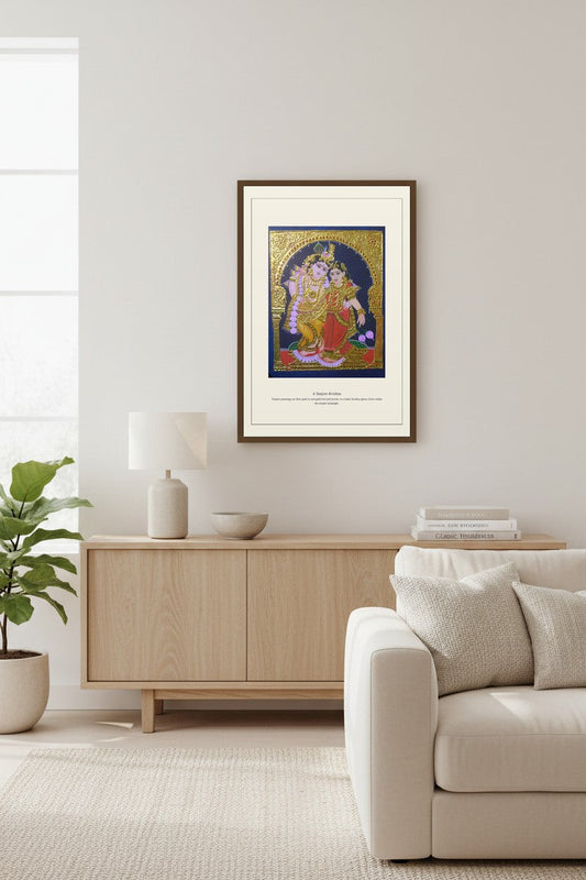 Gold-leaf Tanjore painting print framed above a light wood sideboard