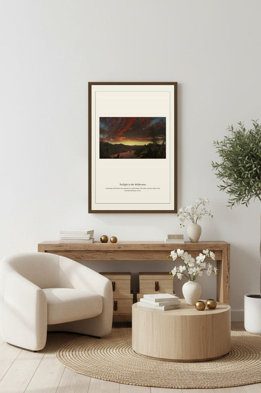 Twilight in the Wilderness landscape print framed above a low console table between a woven armchair and side table