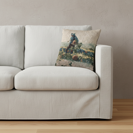 A square throw pillow featuring an impressionist painting of a figure playing a guitar, styled on the arm of a light beige fabric sofa in a minimalist room setting.