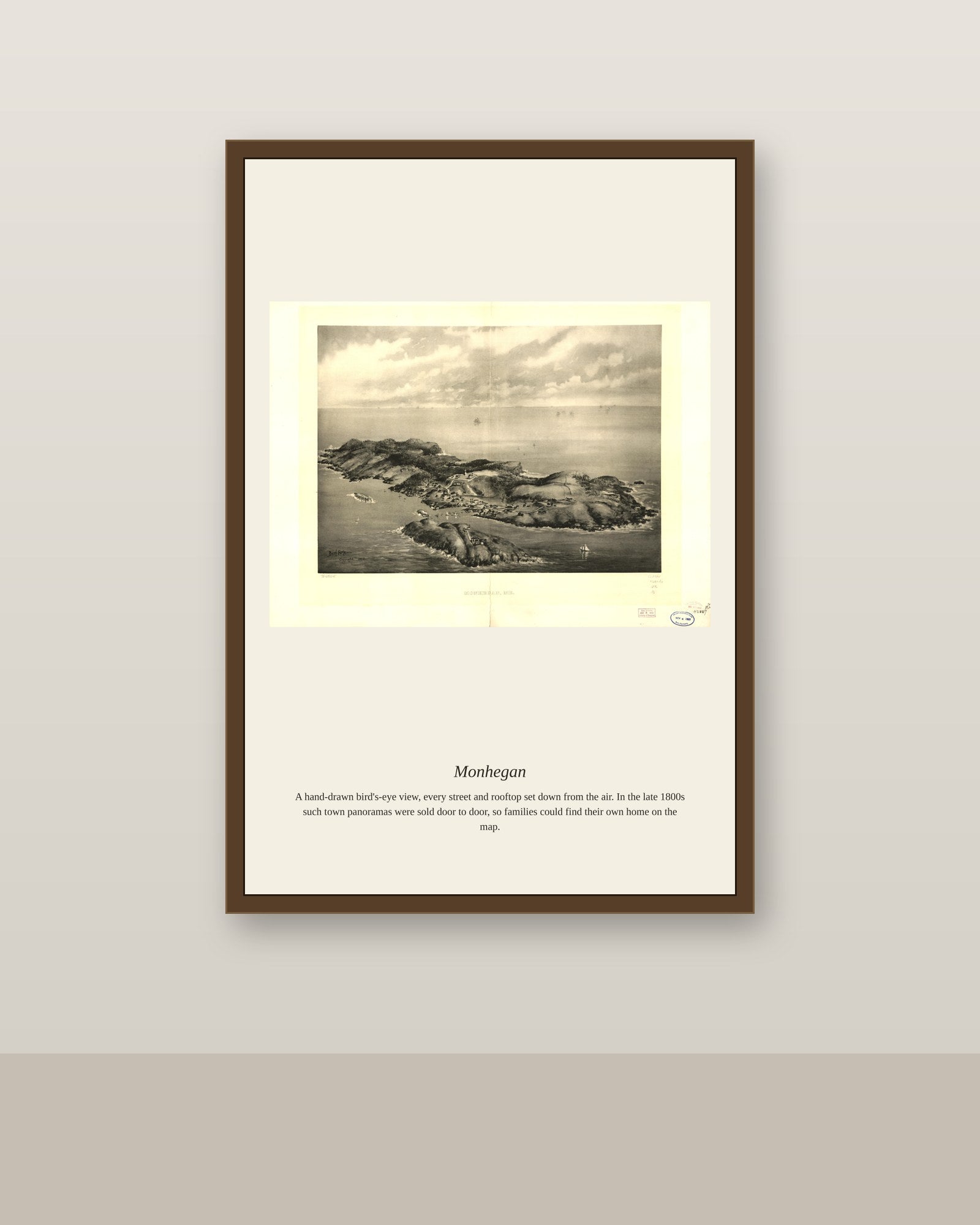 Monhegan antique map print shown framed on a wall in a styled room