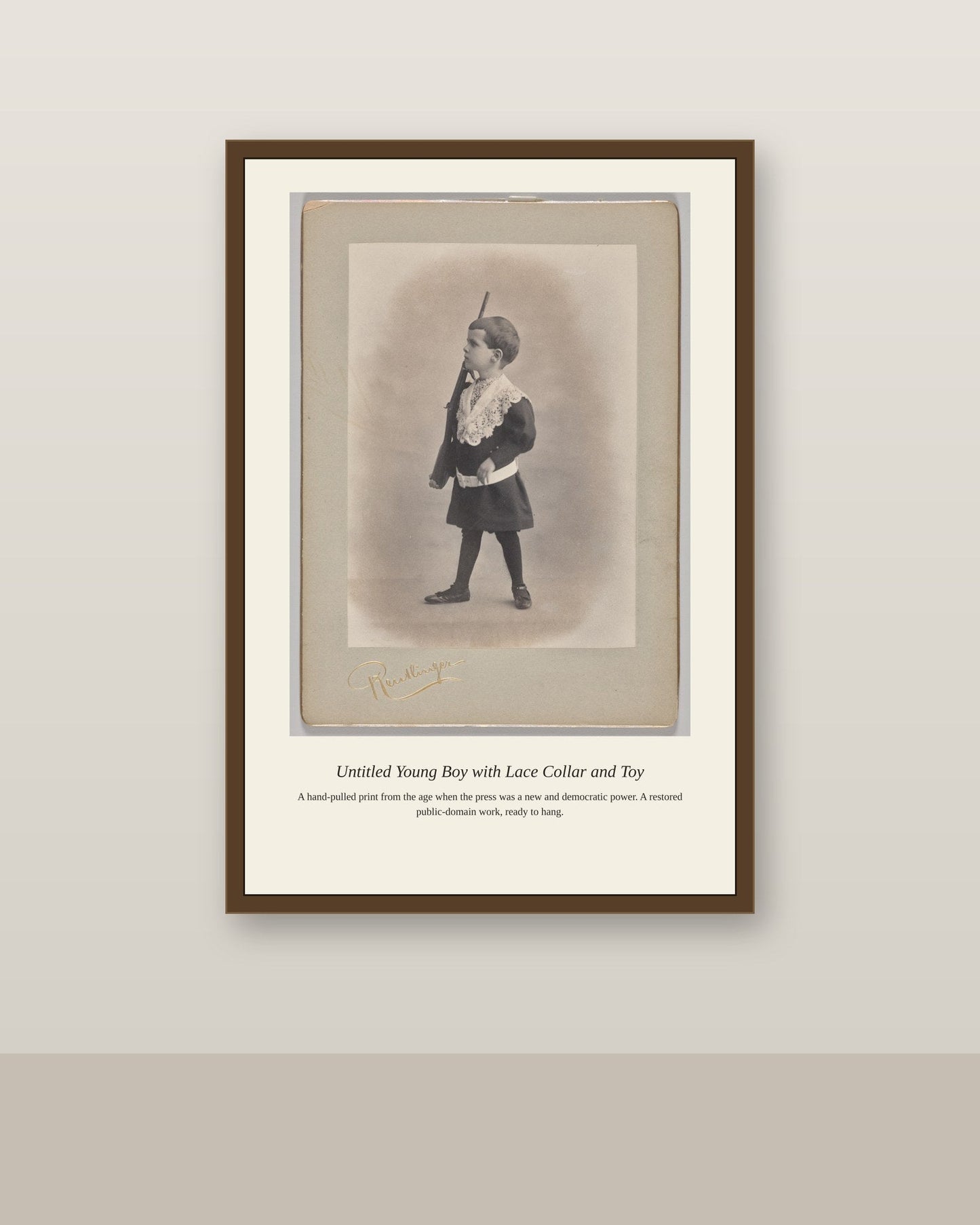 Young Boy with Lace Collar and Toy antique art print shown framed on a wall in a styled room