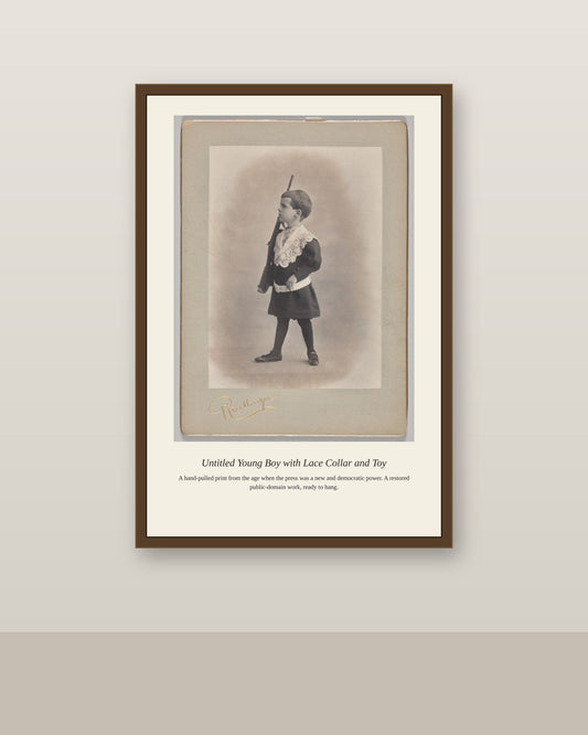 Young Boy with Lace Collar and Toy antique art print shown framed on a wall in a styled room