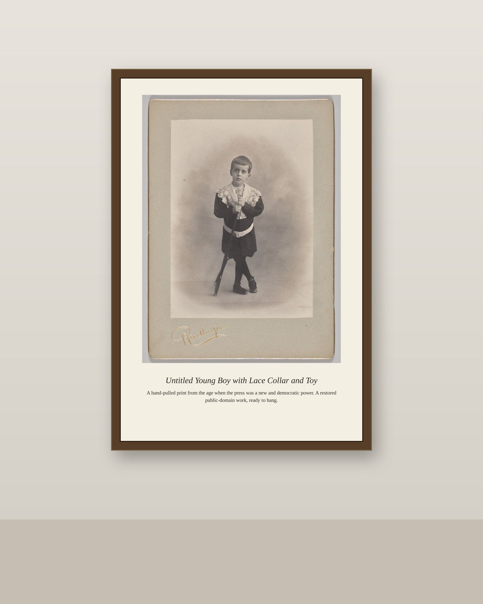 Young Boy with Lace Collar and Toy (2) antique art print shown framed on a wall in a styled room