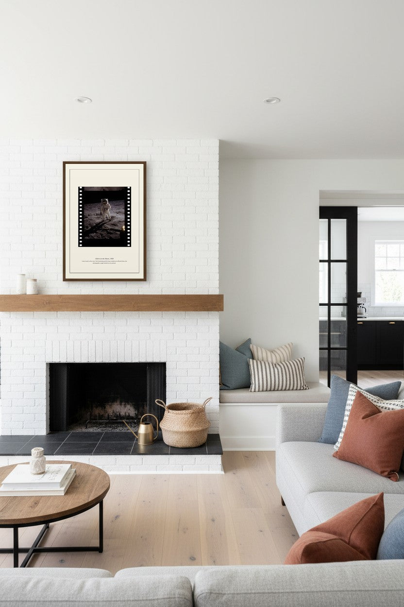 Aldrin on the Moon print hung above a white brick fireplace in a bright living room