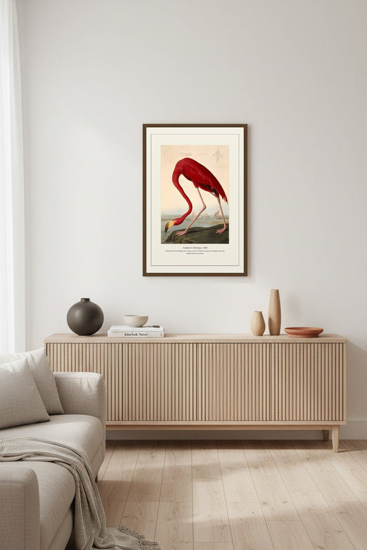Audubon's Flamingo print in a wood frame above a ribbed light sideboard