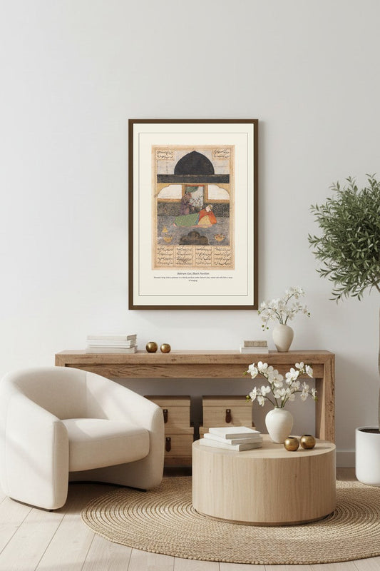 framed Persian pavilion print displayed above a light wood sideboard beside a cream armchair and round jute rug