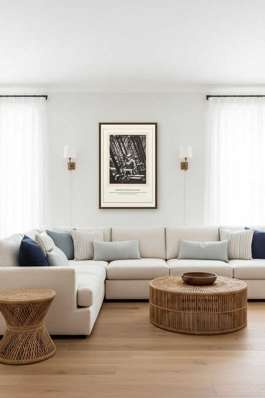 framed aircraft engine factory engraving between two wall sconces above a beige sectional sofa