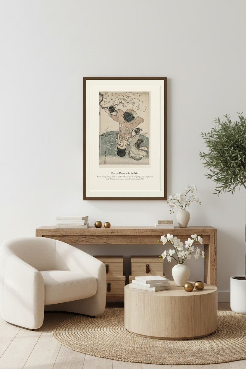 Cherry Blossoms in the Wind framed above a light wood console with a small potted plant