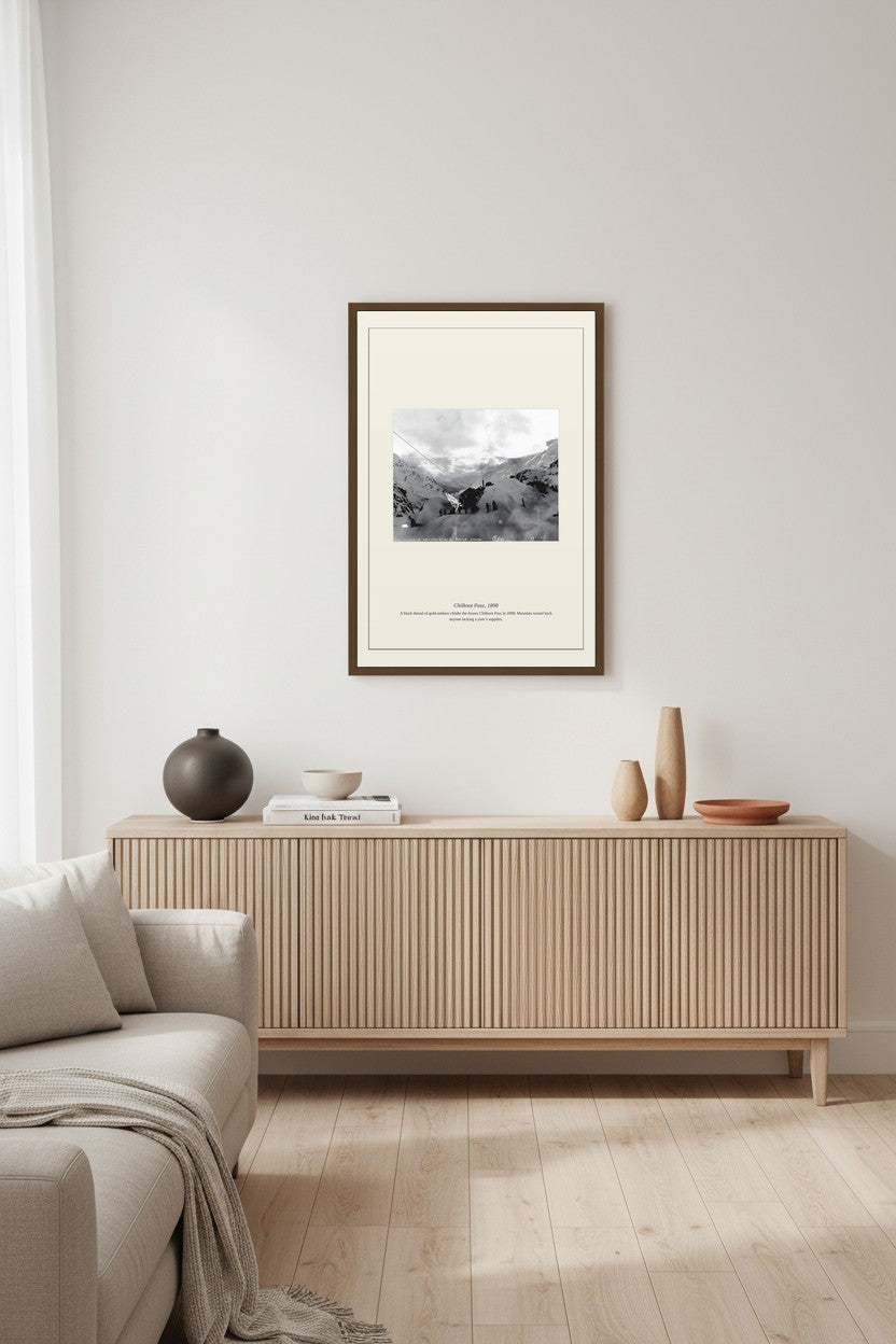 Chilkoot Pass photograph framed above a ribbed wood sideboard in a minimalist living room