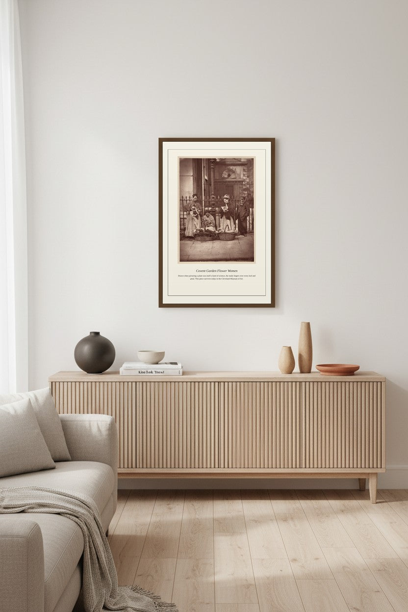 Covent Garden Flower Women print framed above a light wood sideboard in a living room