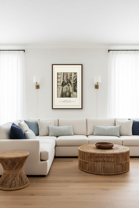 Ellis Island Arrival portrait print framed above a beige sectional in a bright living room