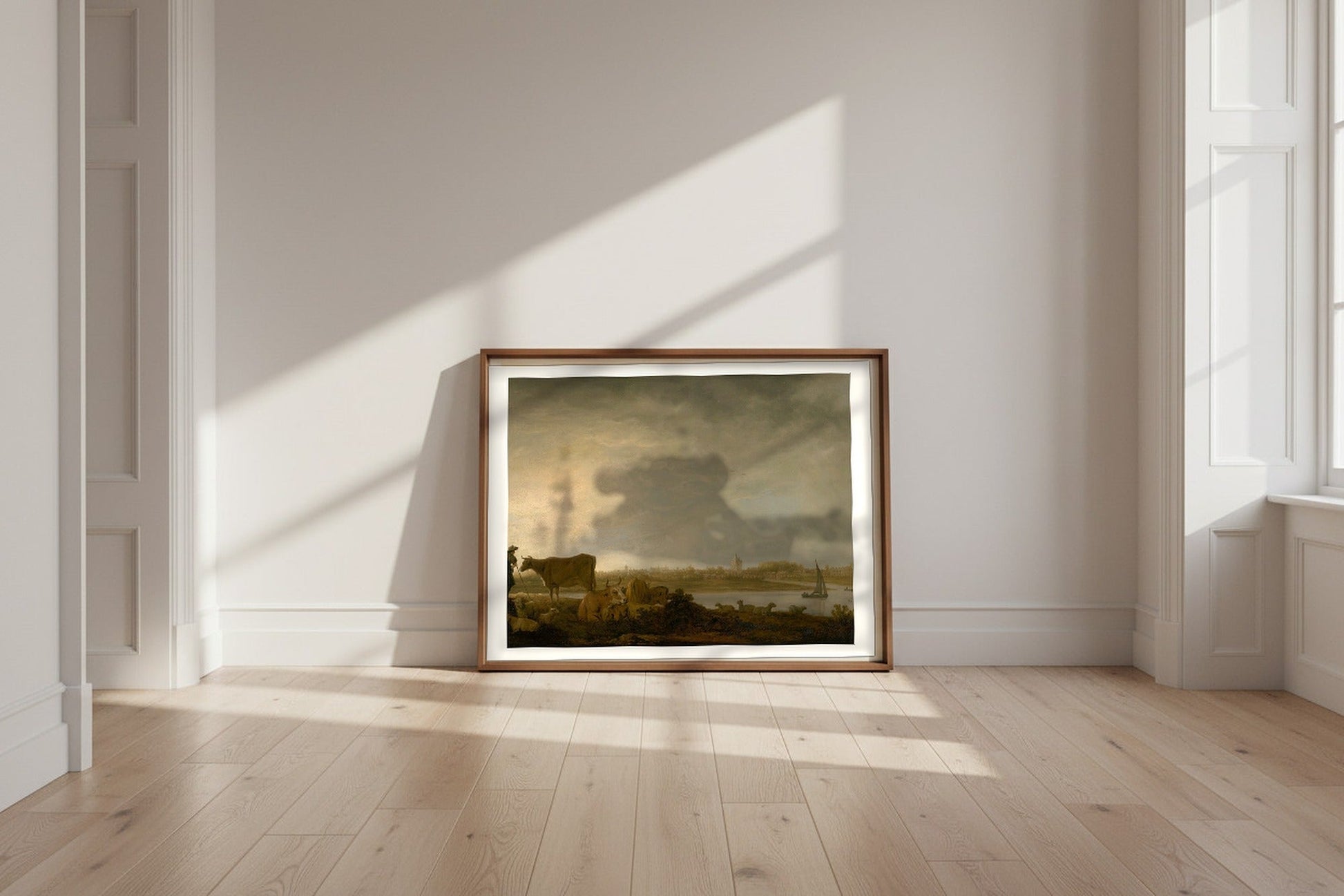 A View of Vianen with a Herdsman and Cattle by a River — Aelbert Cuyp Fine Art Poster shown framed and leaning against a wall in a sunlit room