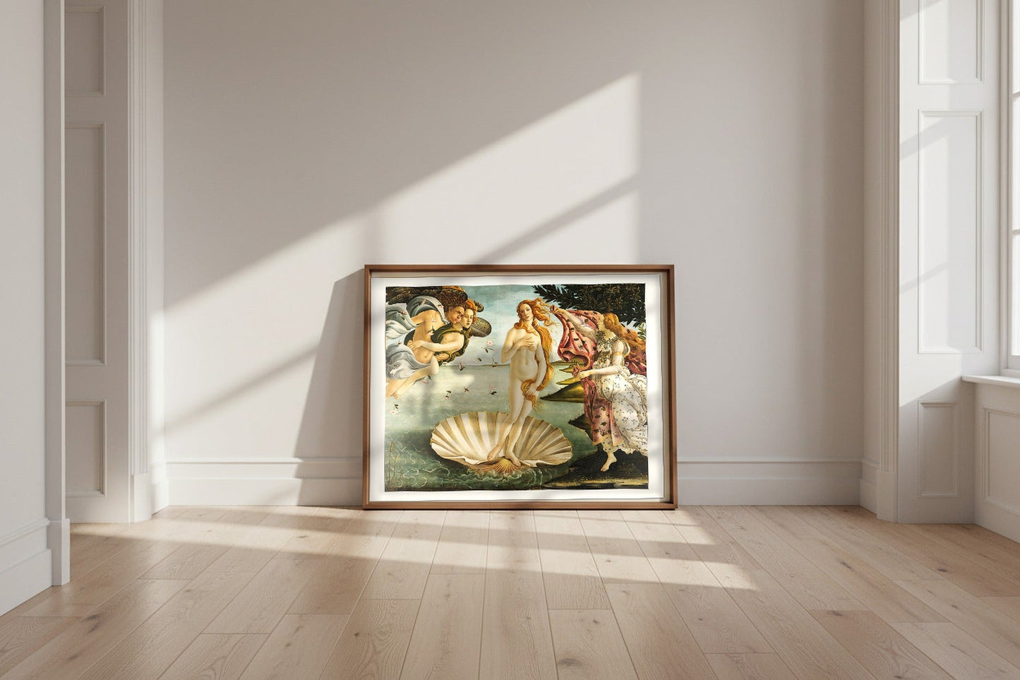 The Birth of Venus — Sandro Botticelli Fine Art Poster shown framed and leaning against a wall in a sunlit room