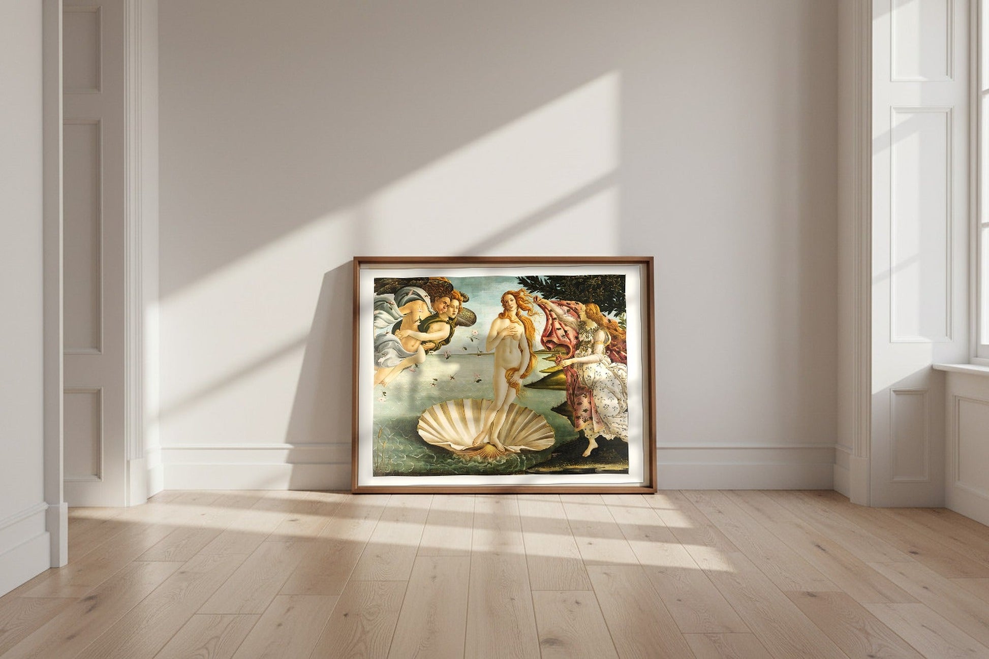 The Birth of Venus — Sandro Botticelli Fine Art Poster shown framed and leaning against a wall in a sunlit room