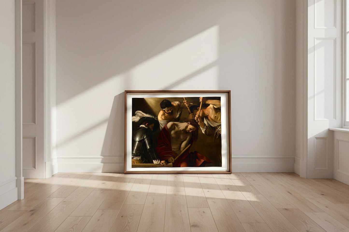 The Crowning with Thorns — Caravaggio Fine Art Poster shown framed and leaning against a wall in a sunlit room