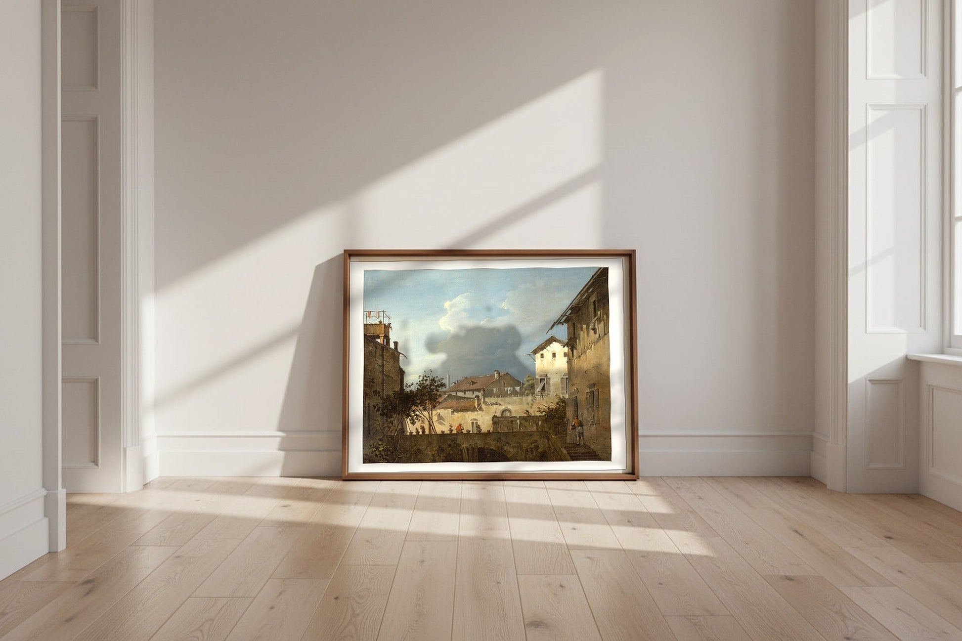 The Terrace (follower of Canaletto) Fine Art Poster shown framed and leaning against a wall in a sunlit room