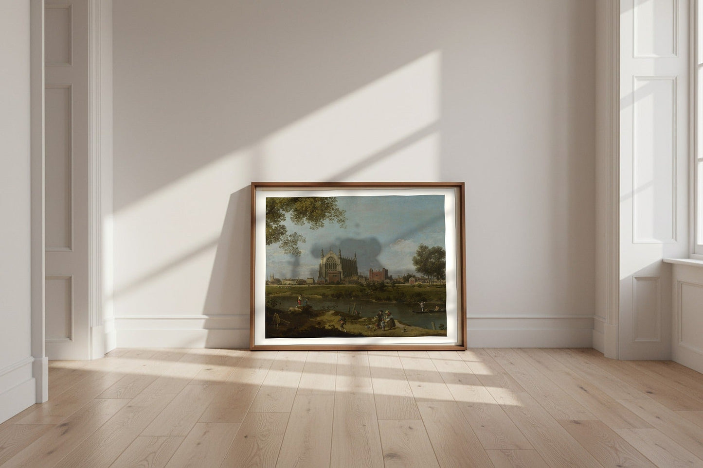 A Venetian Capriccio — Canaletto Fine Art Poster shown framed and leaning against a wall in a sunlit room
