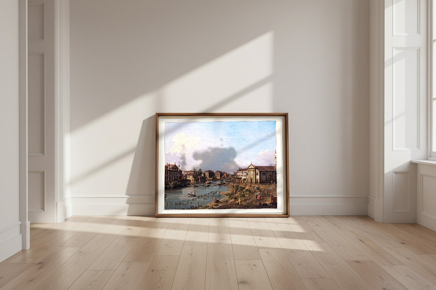 View of Dolo — Canaletto Fine Art Poster shown framed and leaning against a wall in a sunlit room