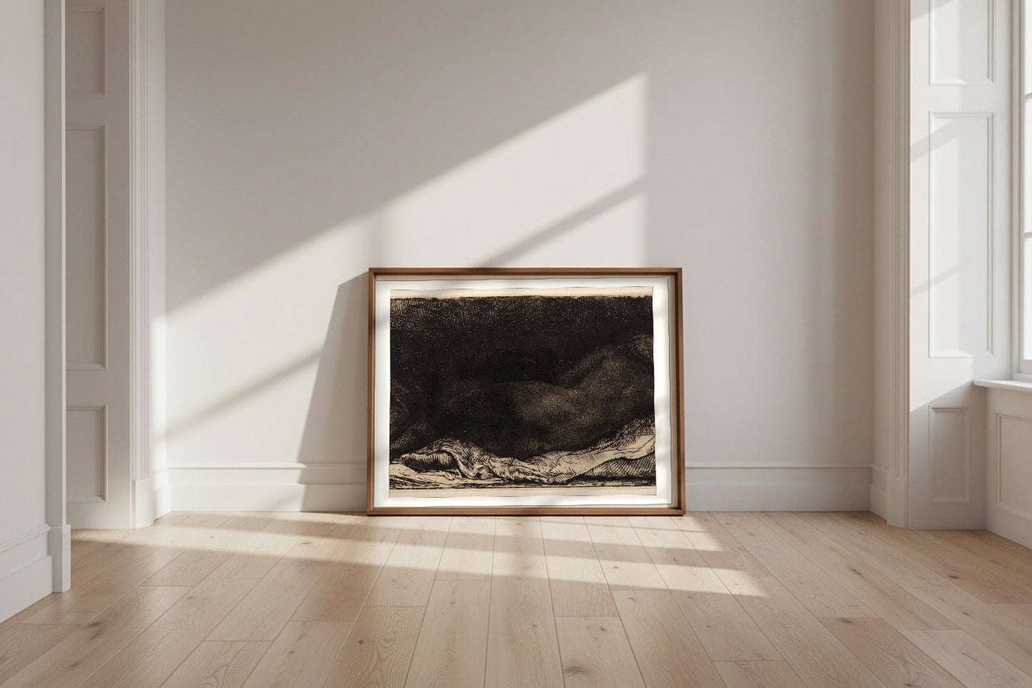Reclining Female Nude — Rembrandt van Rijn Fine Art Poster shown framed and leaning against a wall in a sunlit room