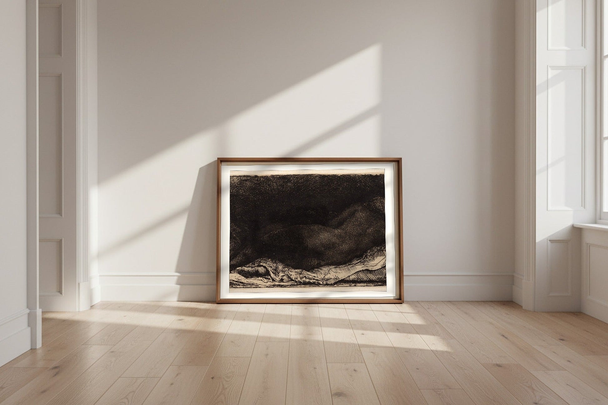 Reclining Female Nude — Rembrandt van Rijn Fine Art Poster shown framed and leaning against a wall in a sunlit room