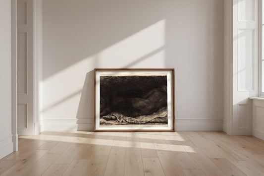 Reclining Female Nude — Rembrandt van Rijn Fine Art Poster shown framed and leaning against a wall in a sunlit room