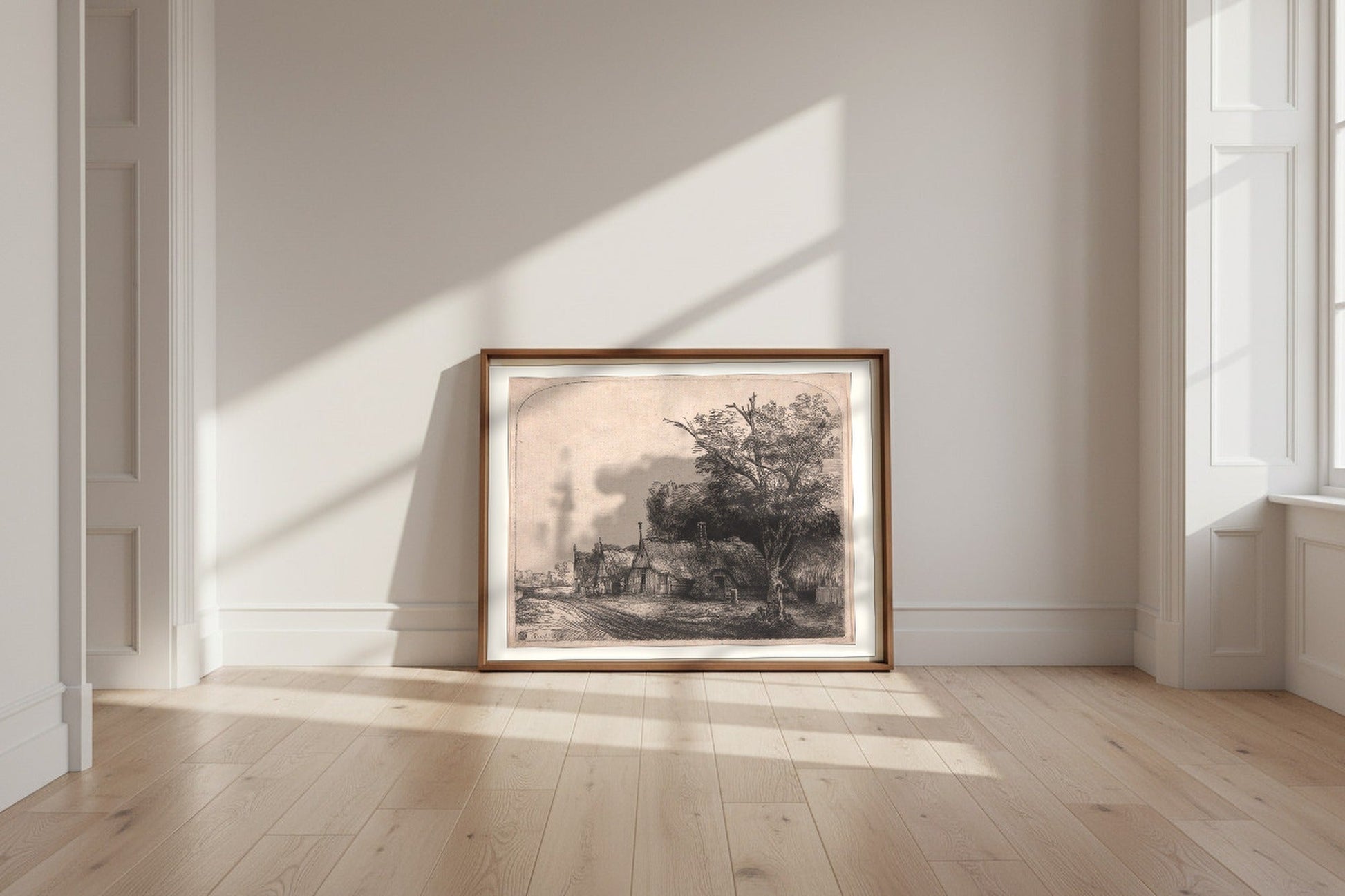Landscape with Three Gabled Cottages Beside a Road — Rembrandt van Rijn Fine Art Poster shown framed and leaning against a wall in a sunlit room