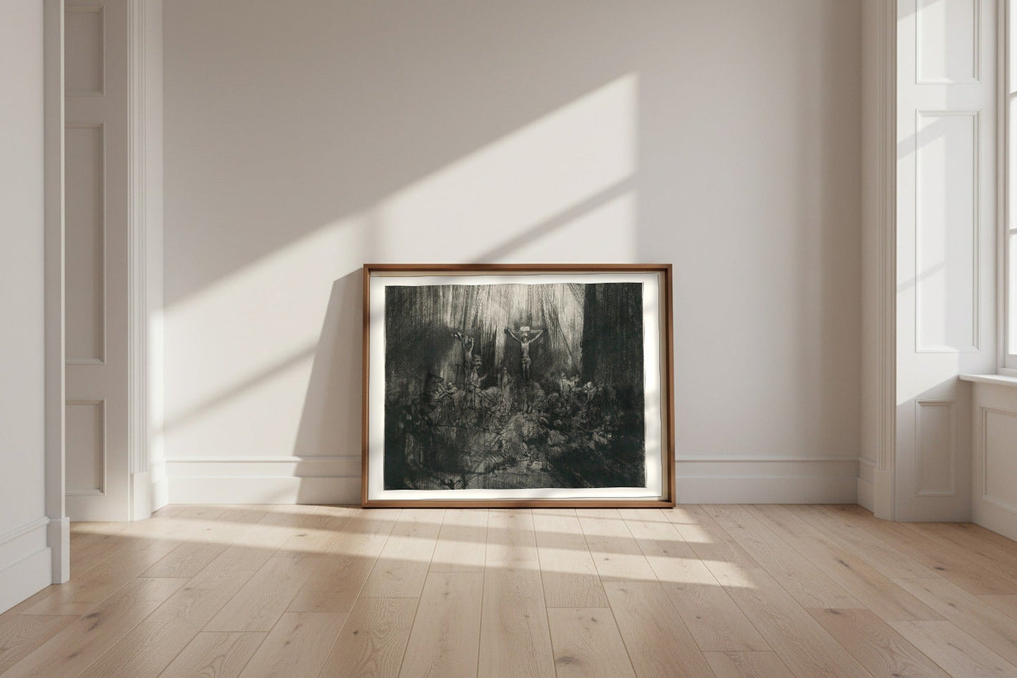 Christ Crucified between the Two Thieves (The Three Crosses) — Rembrandt van Rijn Fine Art Poster shown framed and leaning against a wall in a sunlit room