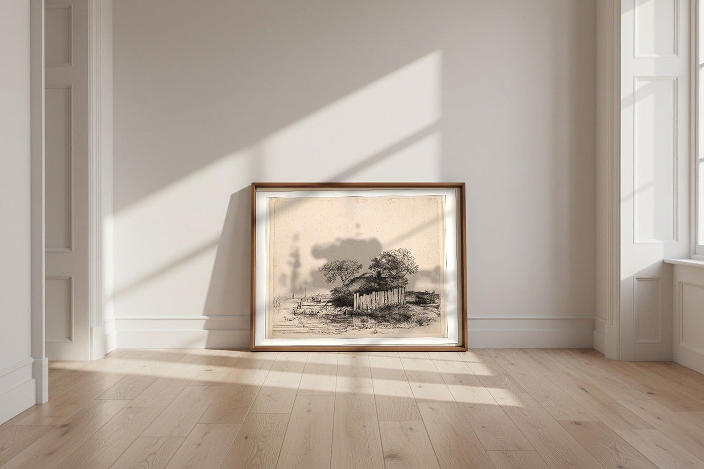 A Cottage with White Paling — Rembrandt van Rijn Fine Art Poster shown framed and leaning against a wall in a sunlit room