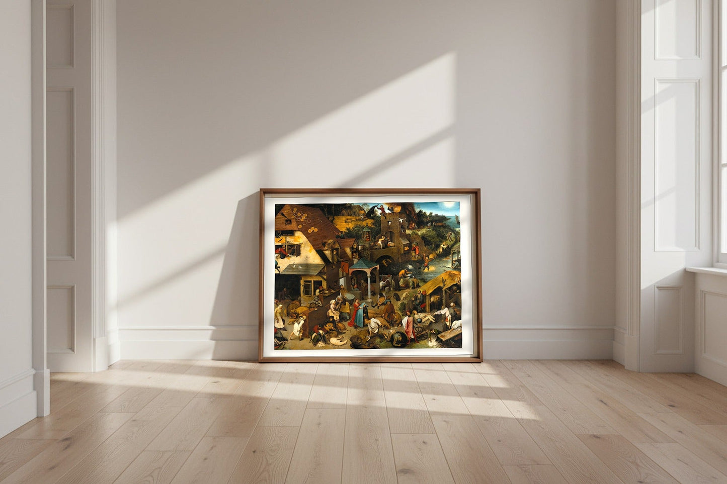 The Dutch Proverbs — Pieter Bruegel the Elder Fine Art Poster shown framed and leaning against a wall in a sunlit room
