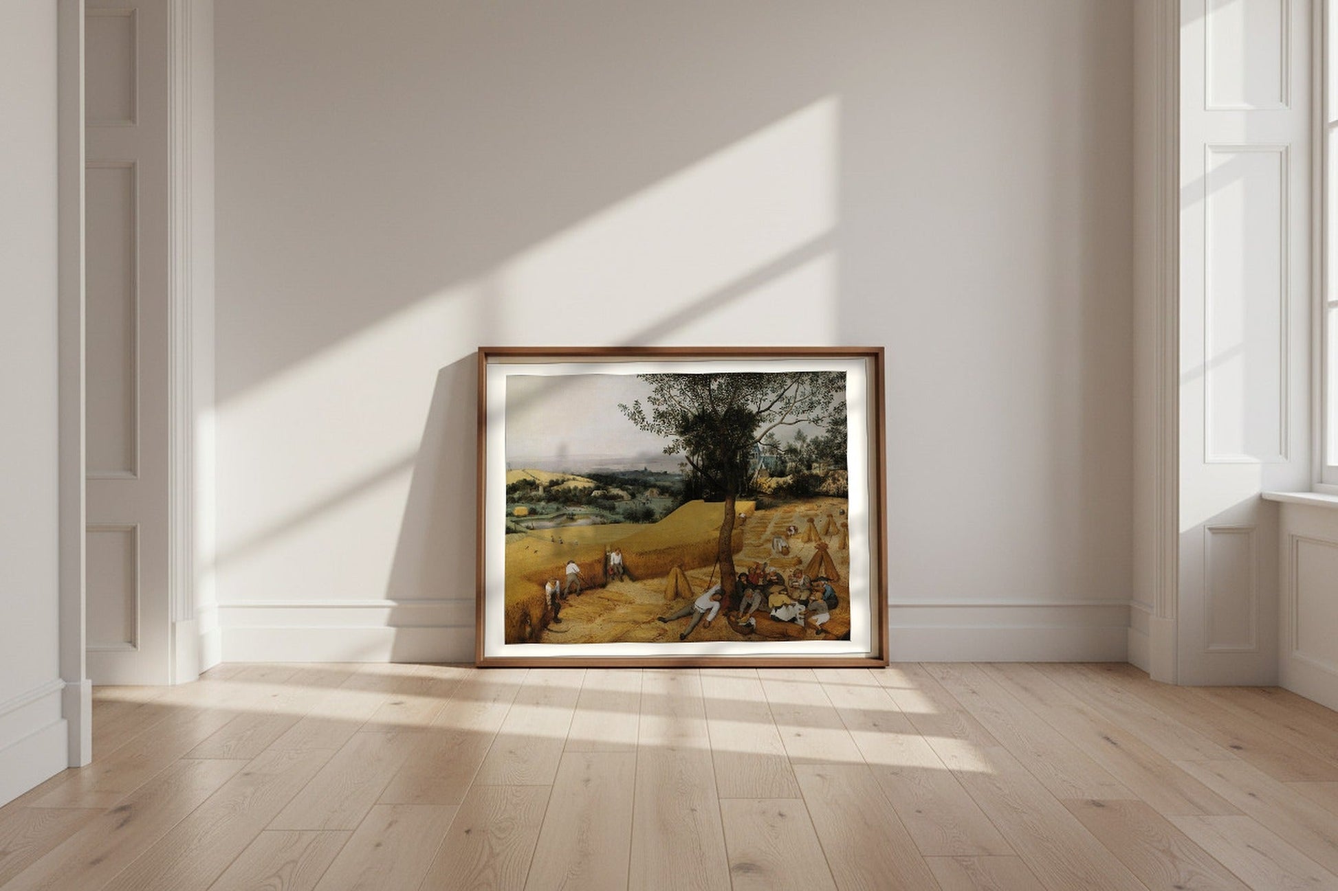 The Harvesters — Pieter Bruegel the Elder Fine Art Poster shown framed and leaning against a wall in a sunlit room