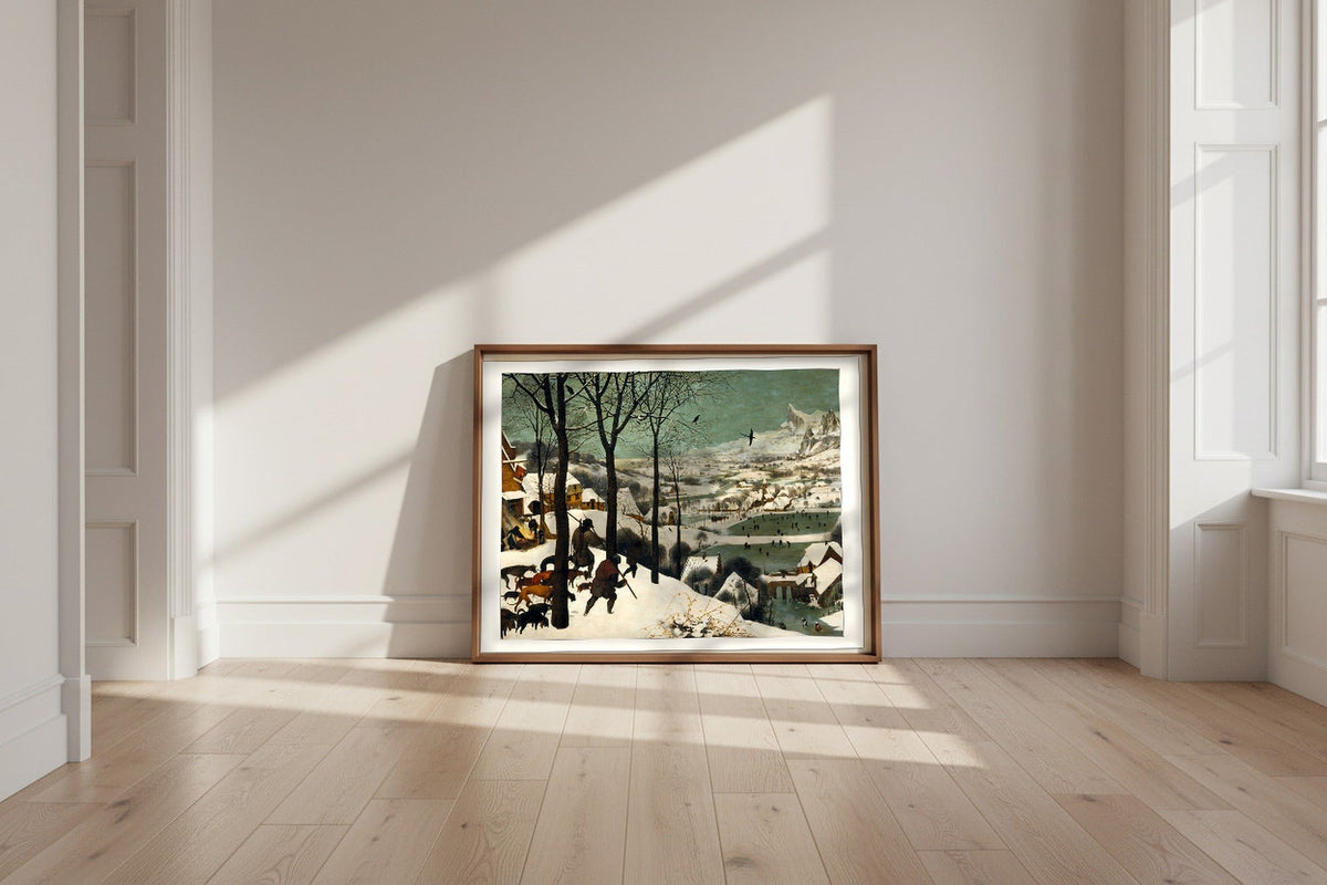 Hunters in the Snow (Winter) — Pieter Bruegel the Elder Fine Art Poster shown framed and leaning against a wall in a sunlit room