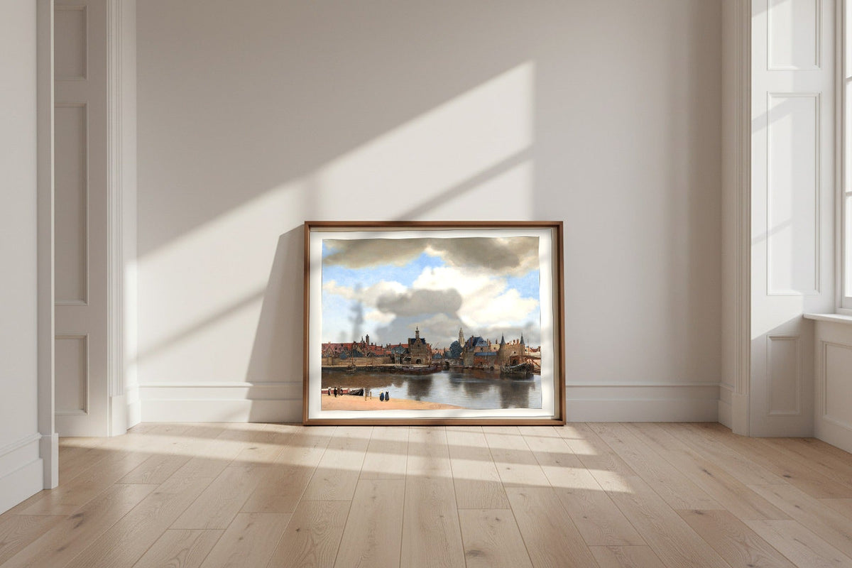 View of Delft — Johannes Vermeer Fine Art Poster shown framed and leaning against a wall in a sunlit room