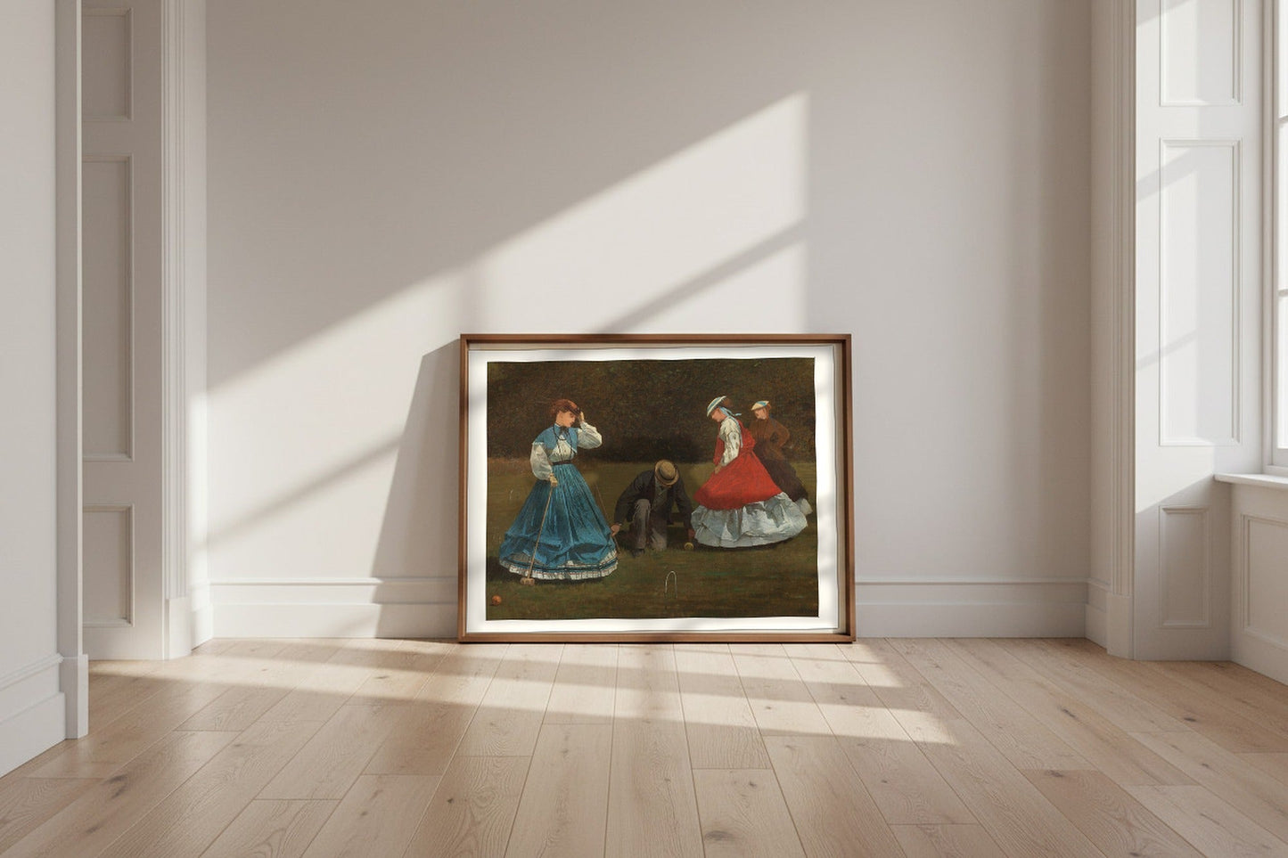 Croquet Scene — Winslow Homer Fine Art Poster shown framed and leaning against a wall in a sunlit room