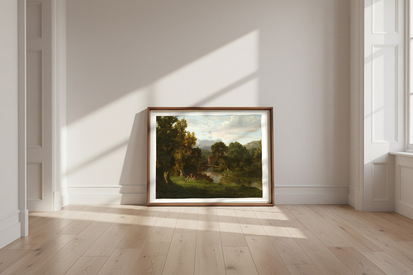 The Old Mill — George Inness Fine Art Poster shown framed and leaning against a wall in a sunlit room