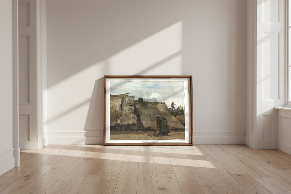 A Peasant Woman Digging in Front of Her Cottage — Vincent van Gogh Fine Art Poster shown framed and leaning against a wall in a sunlit room