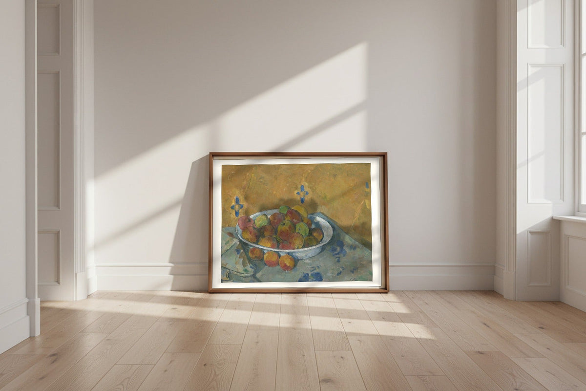 The Plate of Apples — Paul Cézanne Fine Art Poster shown framed and leaning against a wall in a sunlit room