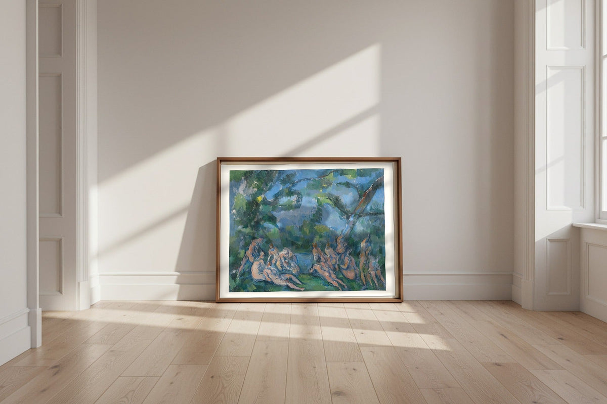 The Bathers — Paul Cézanne Fine Art Poster shown framed and leaning against a wall in a sunlit room